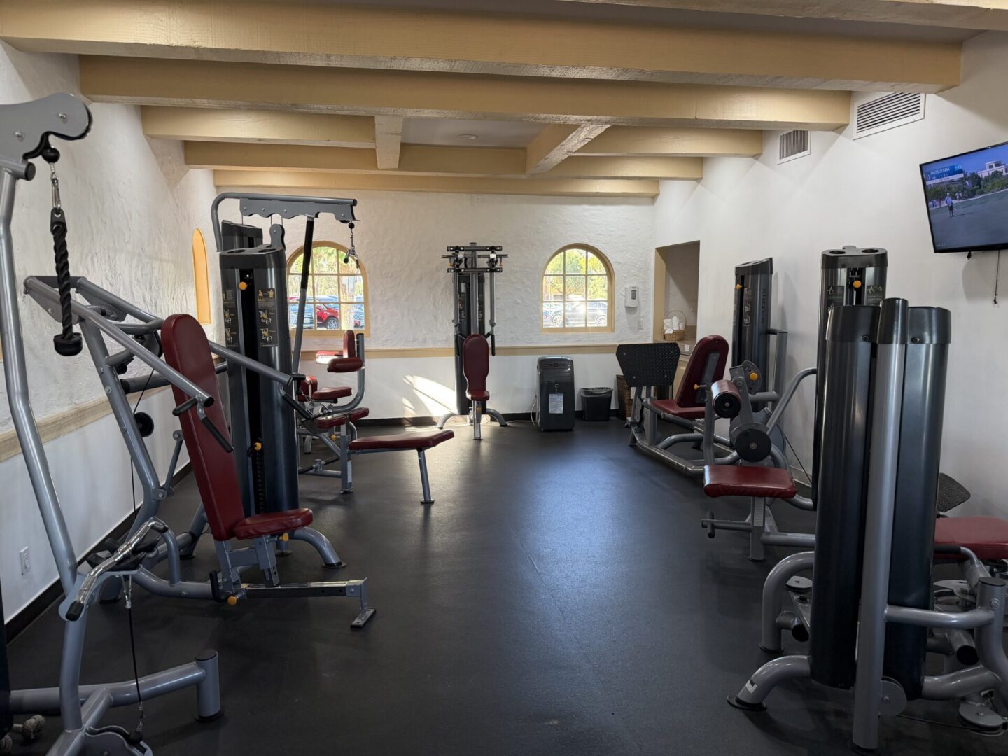 A spacious gym with various exercise machines and equipment.