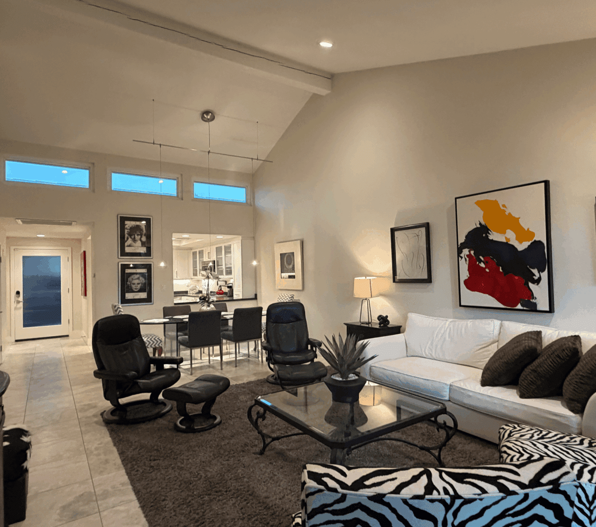 Modern living room with stylish chairs and abstract art.