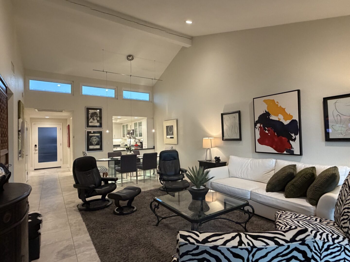 Modern living room with stylish black chairs and abstract art.