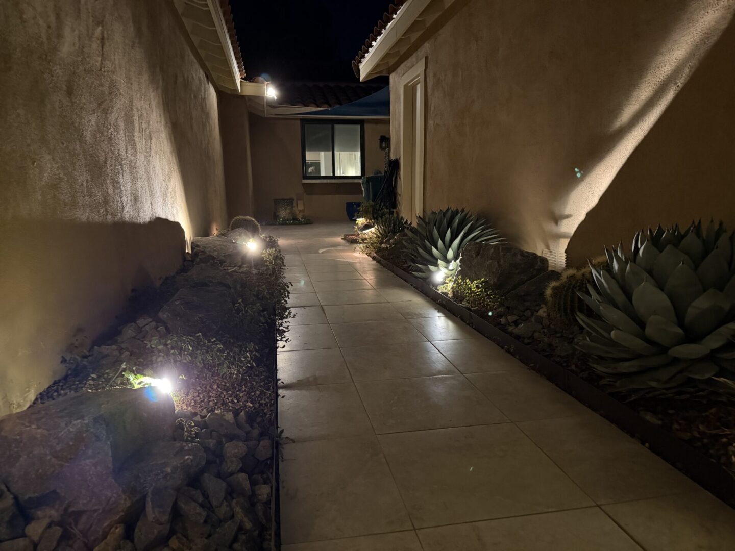 Illuminated pathway with modern lighting at night.