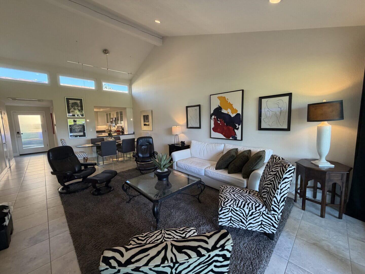 Spacious, stylish living room with modern furniture and vibrant artwork.
