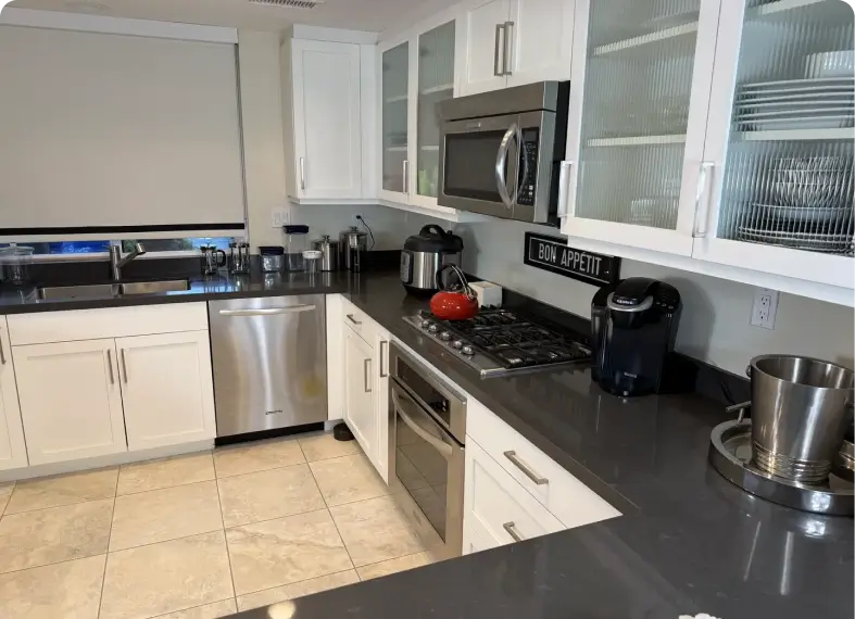 Bright kitchen featuring white cabinets